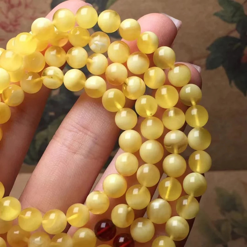 The natural and exquisite Russian honey wax 108 Buddha beads feature a bracelet rich in golden white wax 250424