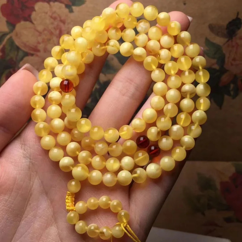The natural and exquisite Russian honey wax 108 Buddha beads feature a bracelet rich in golden white wax 250424