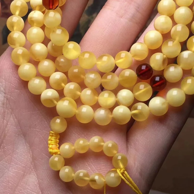 The natural and exquisite Russian honey wax 108 Buddha beads feature a bracelet rich in golden white wax 250424