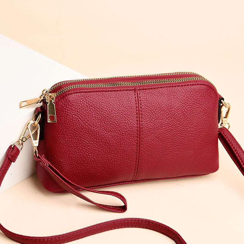 Handheld for women 2025 new fashion Korean version soft leather single shoulder versatile multi-layer small bag hand-held shell bag