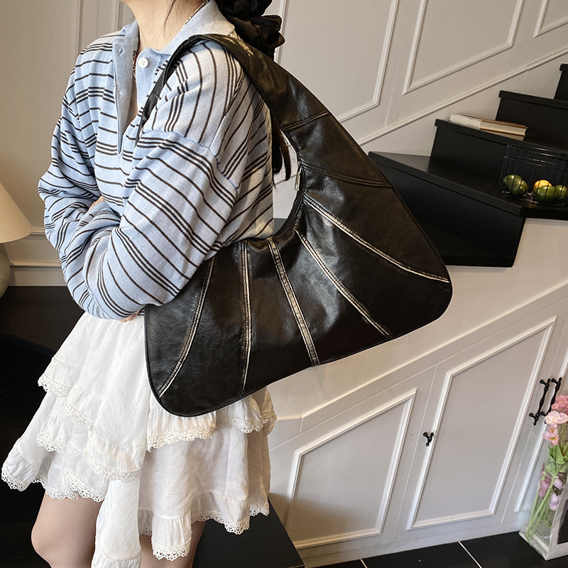 Niche design handbag women's 2025 summer new fashion splicing shoulder commuting armpit bag