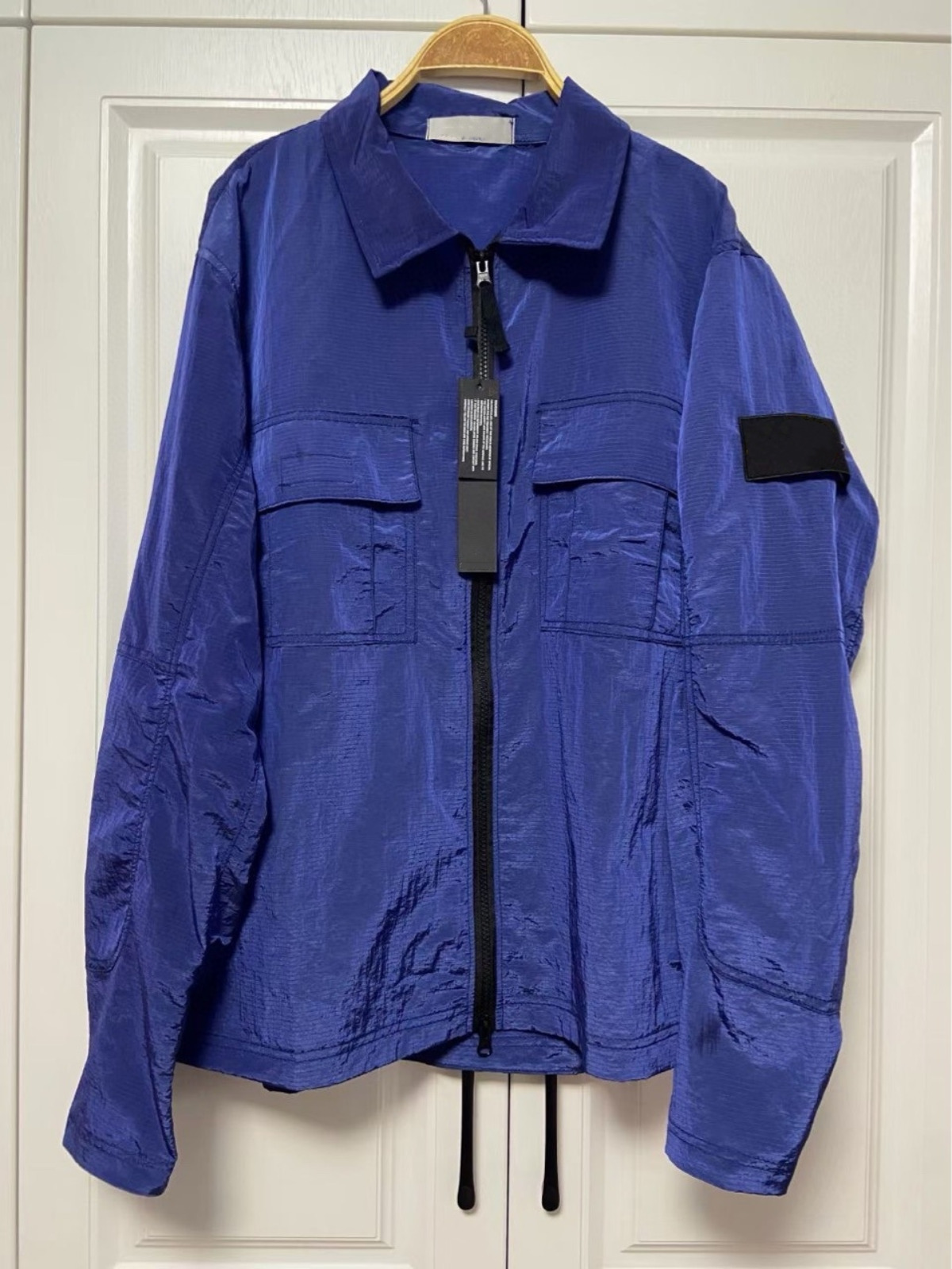 25SS Spring STONE Nylon Meatl Badge Sleeve Patched jackets Women Men Pocket Coat Streetwear Turn Down ISLAND Collars Windbreaker compass coat OFL