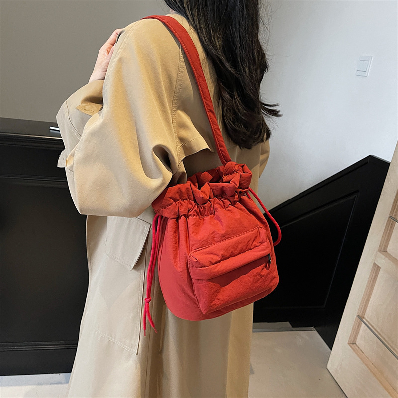2025 new bag 2024 new large capacity women's nylon bucket, Korean version, simple drawstring shoulder bag, designer pleated casual crossbody bag 