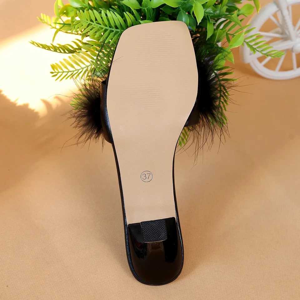 A pair of black womens casual high heels with soft chicken hair design and black high-heeled sandals W250514