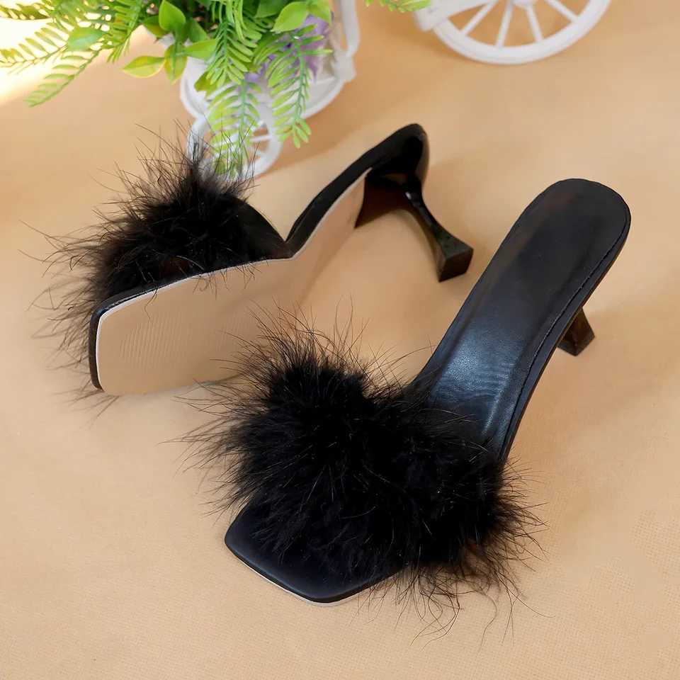A pair of black womens casual high heels with soft chicken hair design and black high-heeled sandals W250514