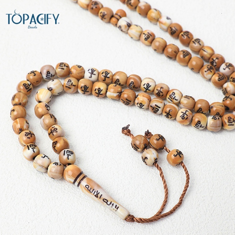 Muslim held in hand, counting 99 beads. Arabic bracelet prayer beads