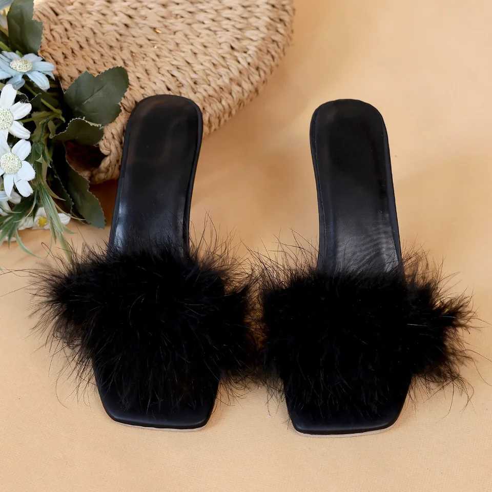 A pair of black womens casual high heels with soft chicken hair design and black high-heeled sandals W250514