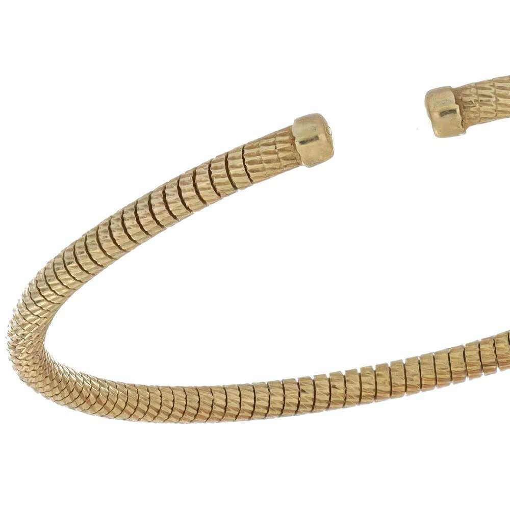 Made in Italy, this elegant handmade open bracelet features a unique and flexible gold design