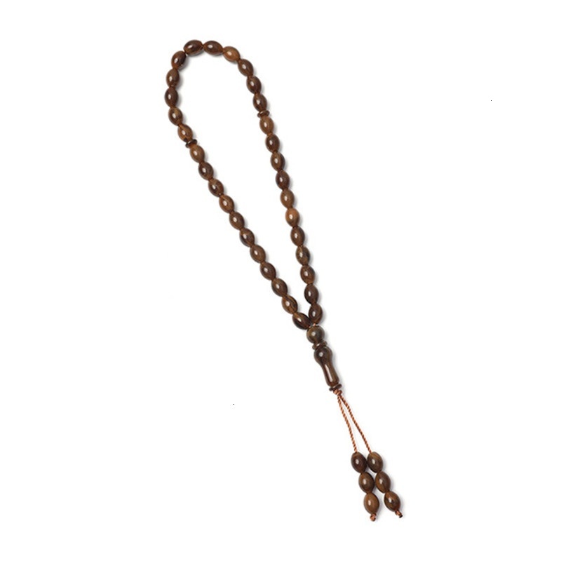 Islamic bead bracelet with 33 Misbaha prayer beads held in hand