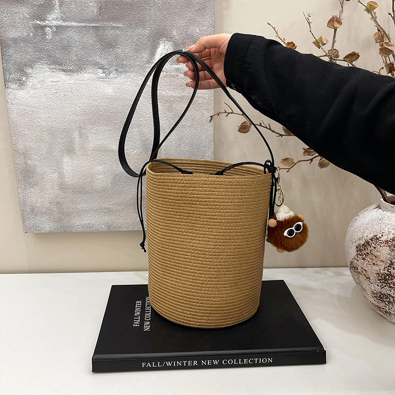 Grass woven summer niche designer style bucket bag, sloping back, one shoulder, handheld INS beach bag for women