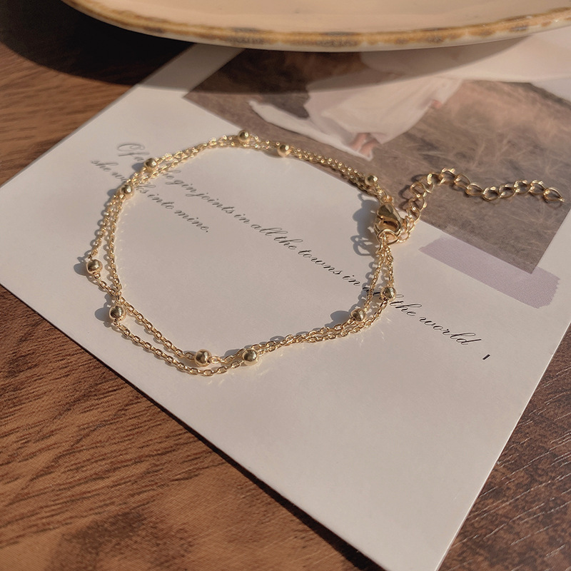 Minimally designed metal bead chain double layered women's bracelet with delicate clip on beads