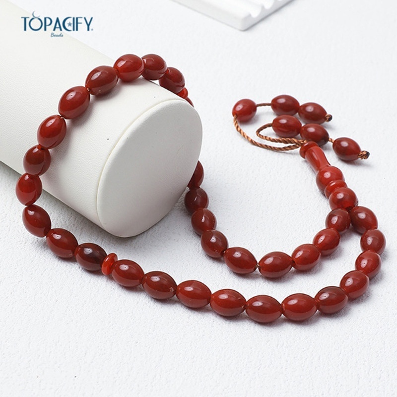 Islamic bead bracelet with 33 Misbaha prayer beads held in hand