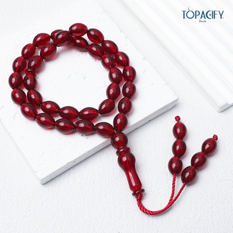 Islamic bead bracelet with 33 Misbaha prayer beads held in hand
