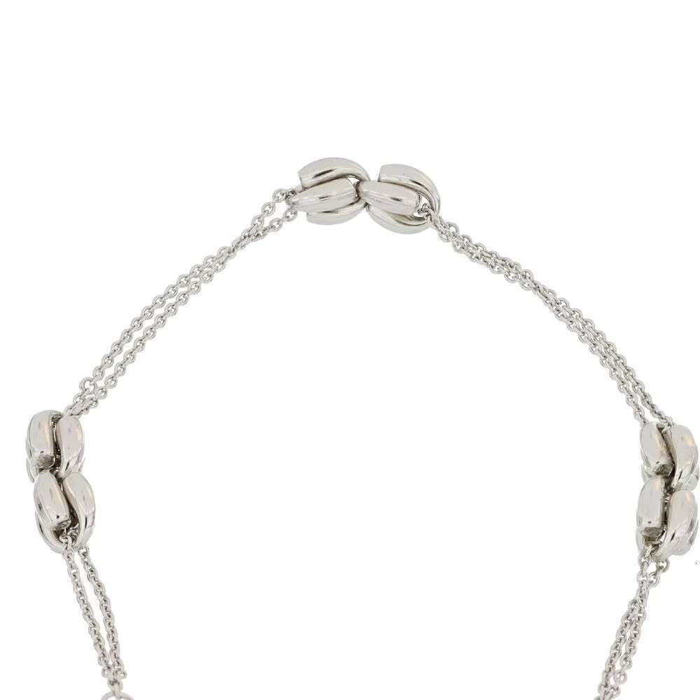 Made in Italy, this pure sier bracelet features a stylish adjustable design with double chain and knot decorations