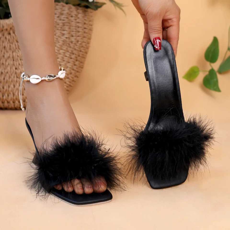 A pair of black womens casual high heels with soft chicken hair design and black high-heeled sandals W250514