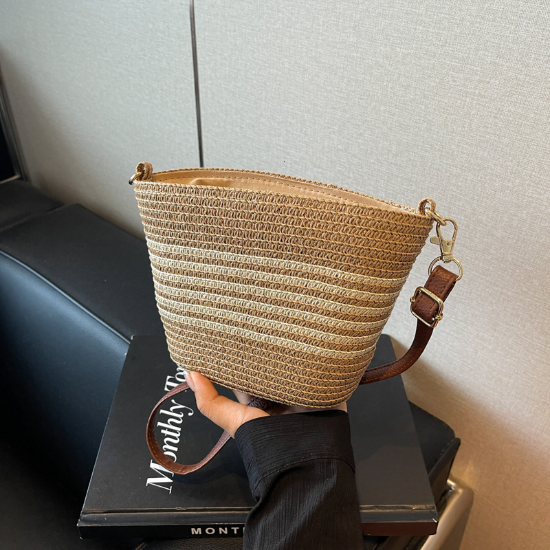 2025 new grass woven striped French beach designer retro high-end multifunctional vacation woven bucket shoulder horizontal mobile phone bag