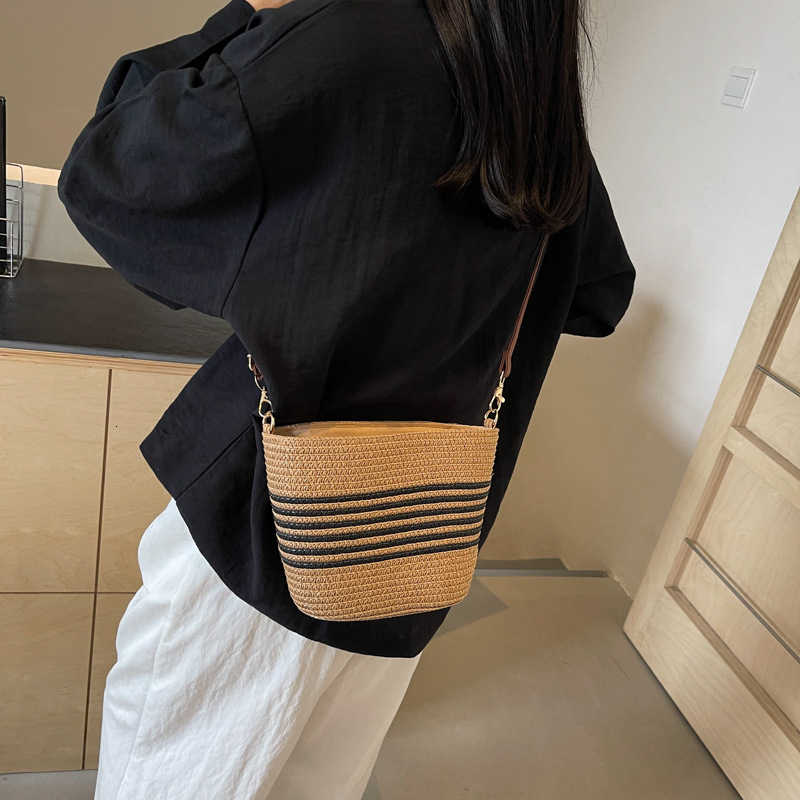 2025 new grass woven striped French beach designer retro high-end multifunctional vacation woven bucket shoulder horizontal mobile phone bag