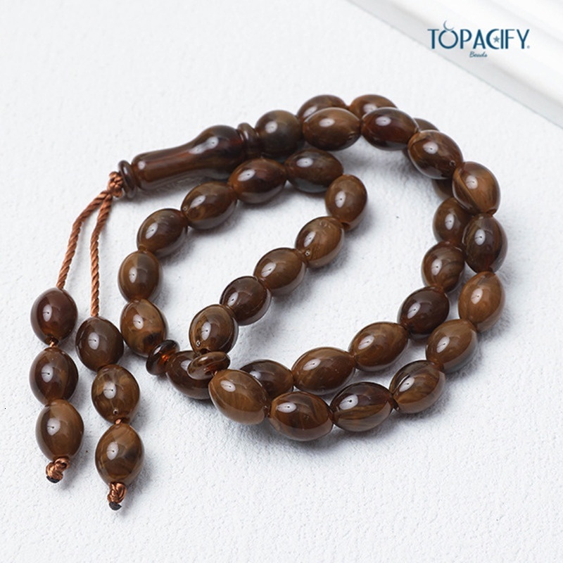 Islamic bead bracelet with 33 Misbaha prayer beads held in hand