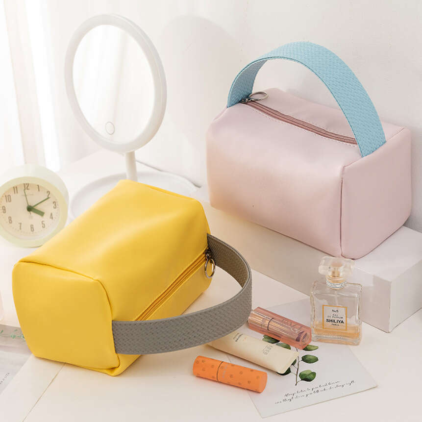 Candy colored bag with high-end storage, large capacity handheld PU waterproof makeup bag, high beauty women's handbag