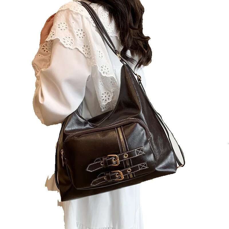 Top brand new free delivery designer bag women's new bag high-end feeling university style student shoulder bag with needle decoration buckle mot