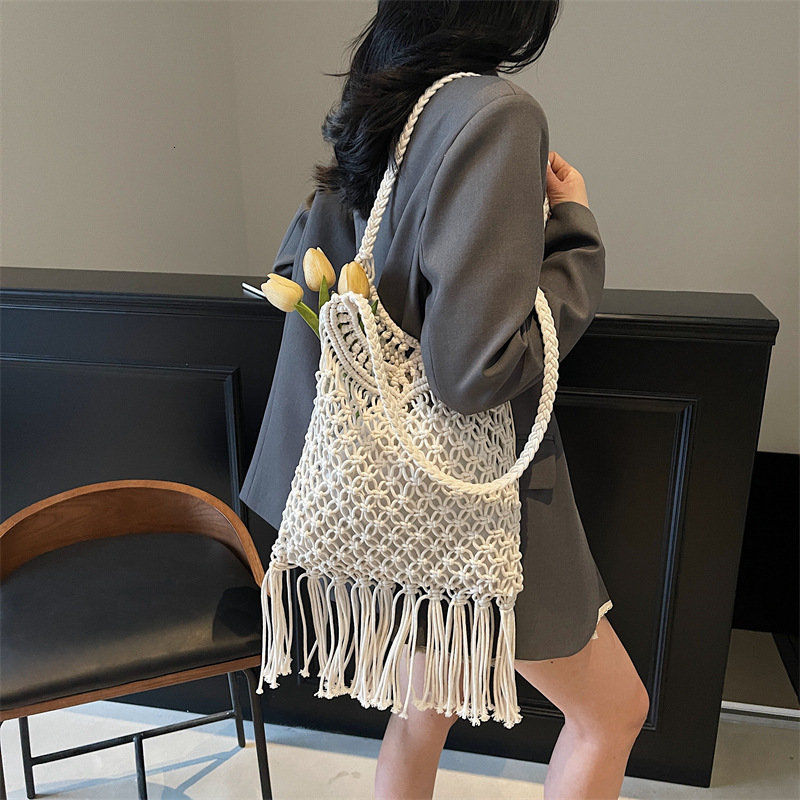 Hollow out cotton thread for women 2025 summer new tassel grass woven bag, vacation style beach versatile armpit shoulder bag