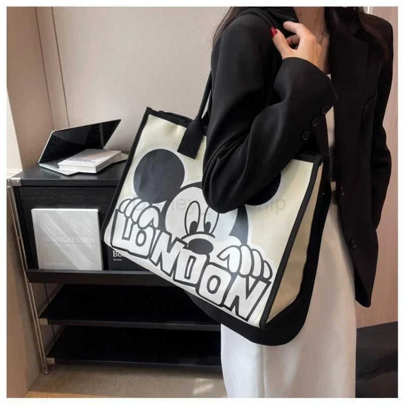 Disney New Disney Mickey Canvas Bag Womens Versatile Casual Shoulder Bag Commuter Handbag Large Capacity Multifunctional Mommy BagXJ250515