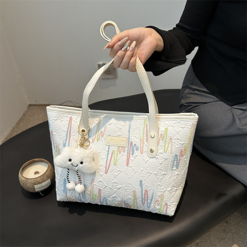 Handheld large capacity tote for women in autumn and winter 2025, new color blocking casual striped versatile high-end shoulder bag