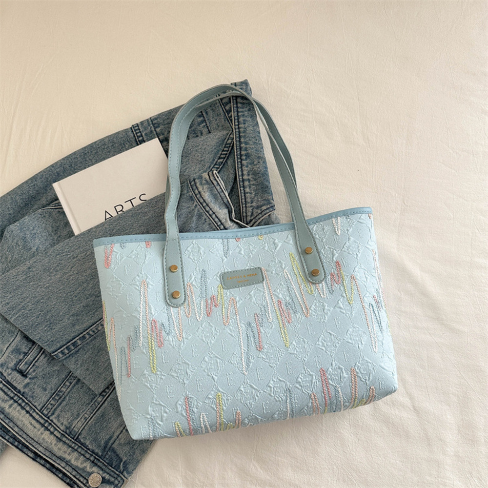 Handheld large capacity tote for women in autumn and winter 2025, new color blocking casual striped versatile high-end shoulder bag
