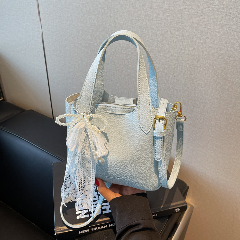 New high-end women's simple handbag for spring and summer with lychee pattern bow and ribbon designer single shoulder crossbody bag commuting sol
