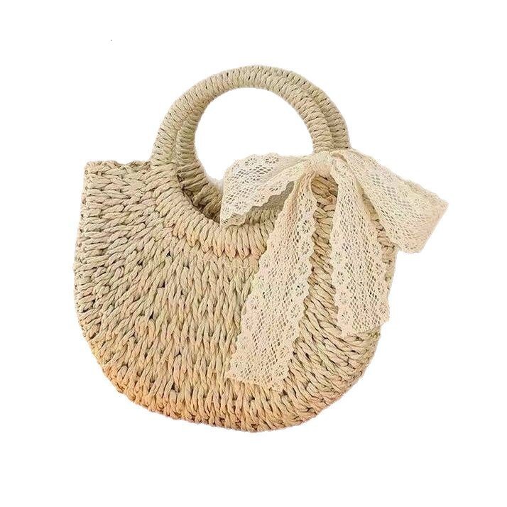 New spring and summer niche semi-circular grass woven leisure vacation style beach bag designer women's hand-held crossbody bag hollowed out tren