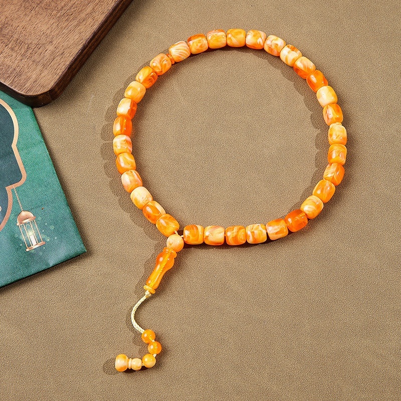 Cylindrical Buddhist with Cook holding 33 praise beads, Muslim prayer bead bracelet