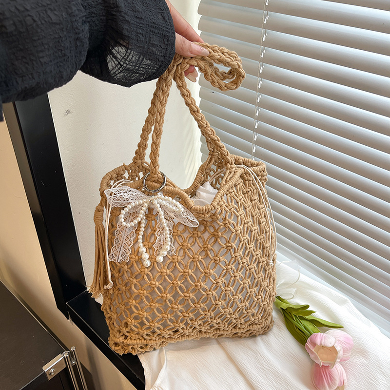 2025S designer large capacity hollow hand women summer new vacation beach shoulder leisure water bucket straw woven bag small square bag