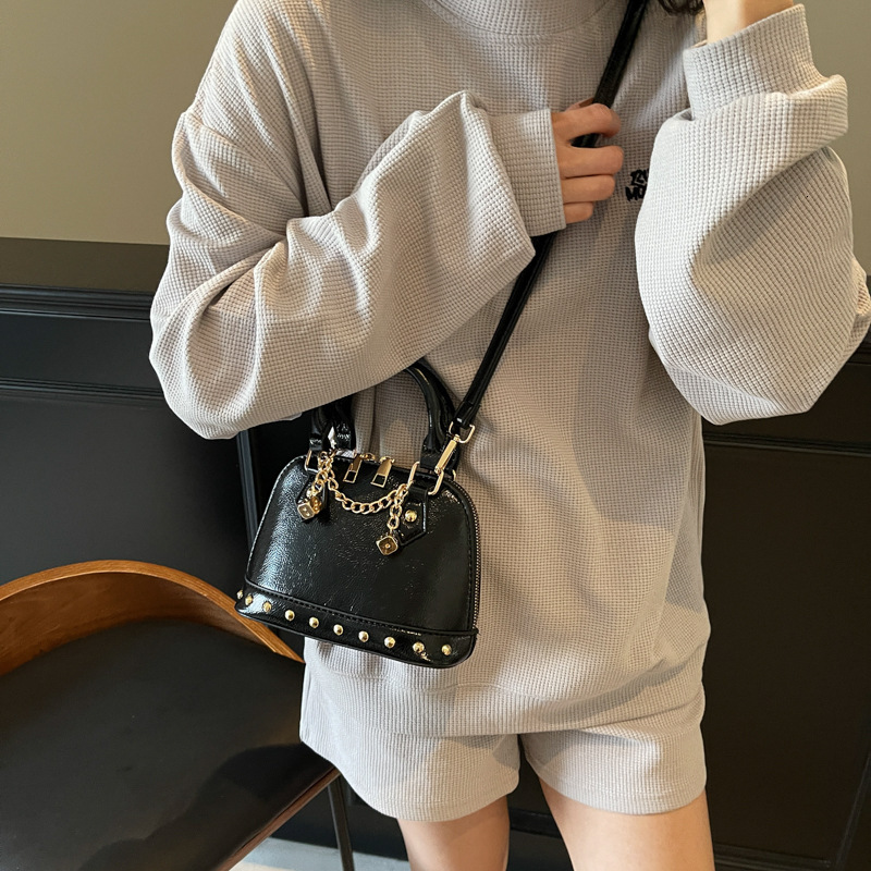 2025 new niche design high-end rivet hand-held shell versatile chain shoulder diagonal cross women's bag