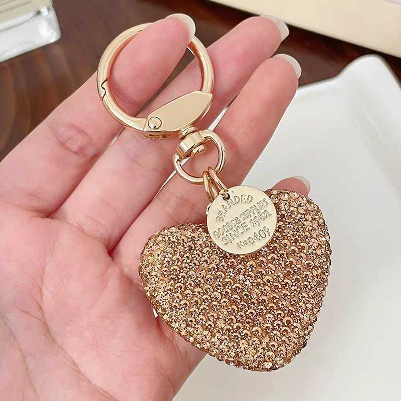Shining diamond studded heart-shaped keychain, peach heart earphone cover, bag pendant, metal tag accessory