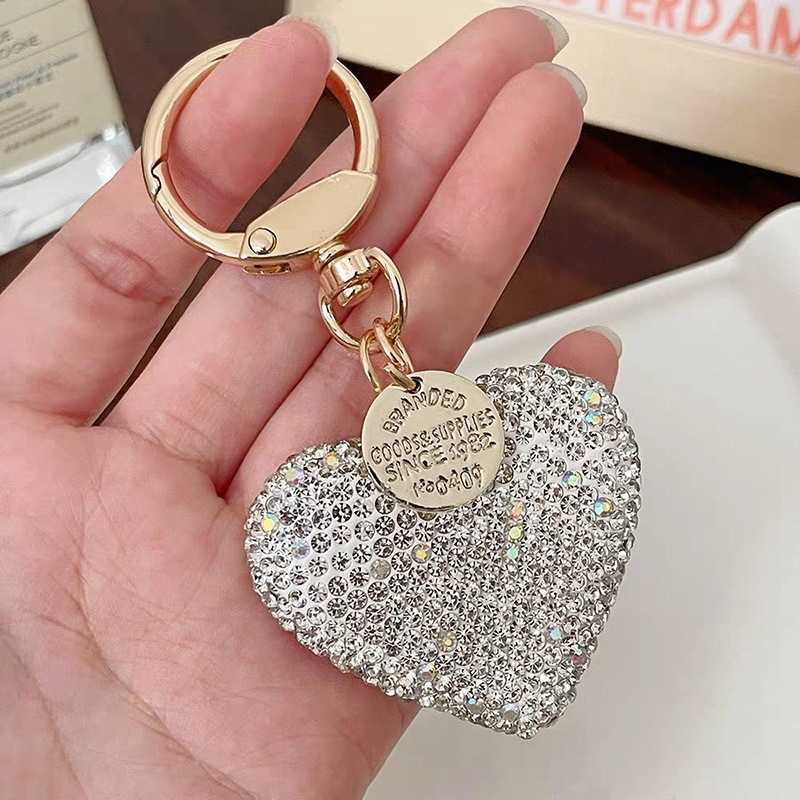 Shining diamond studded heart-shaped keychain, peach heart earphone cover, bag pendant, metal tag accessory