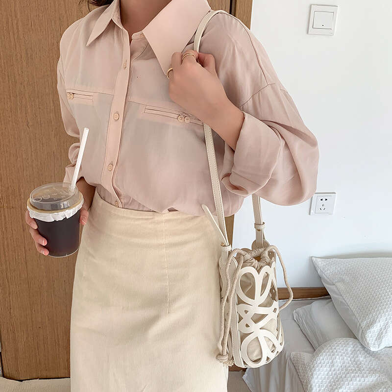 South Korea 2025 new bucket women's hollow drawstring canvas inner niche design fashionable versatile mini bag
