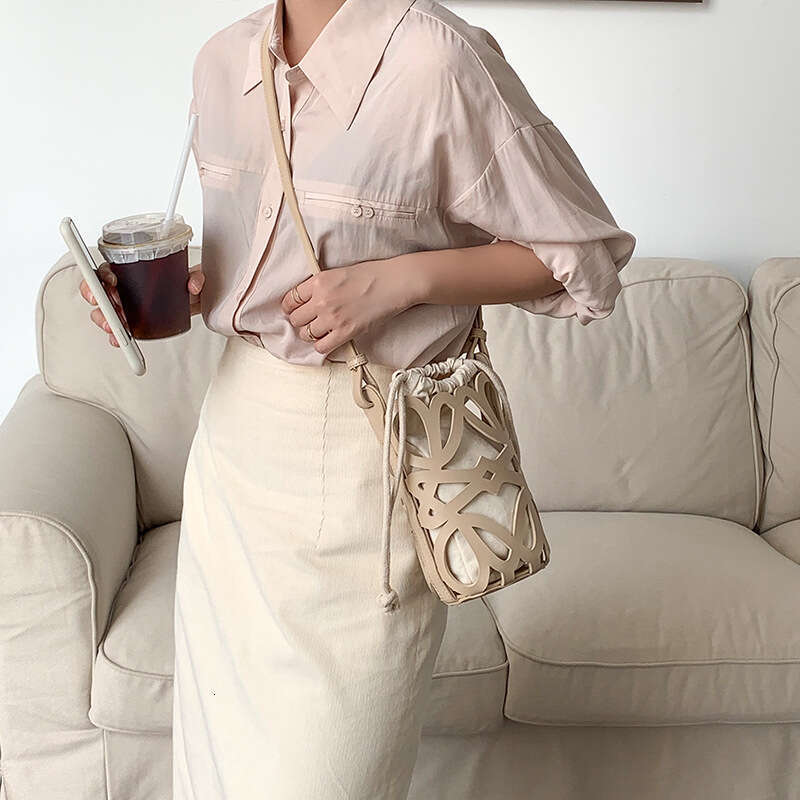 South Korea 2025 new bucket women's hollow drawstring canvas inner niche design fashionable versatile mini bag