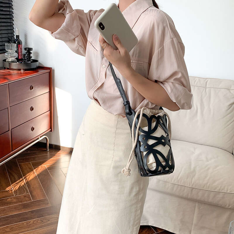 South Korea 2025 new bucket women's hollow drawstring canvas inner niche design fashionable versatile mini bag