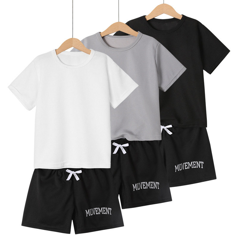 Summer boys' shorts set with waffle style short sleeves and letter printed shorts, suitable for children aged 4-12, featuring a stylish casual ou