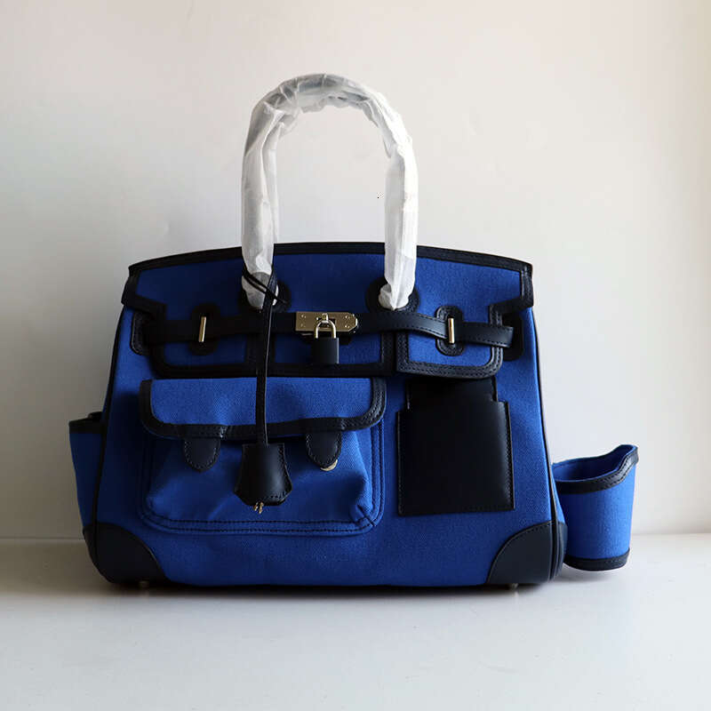 TIINO Canvas Splicing Drawstring Buckle Tote Single Shoulder Diagonal Crossover Head Layer Cowhide Handbag