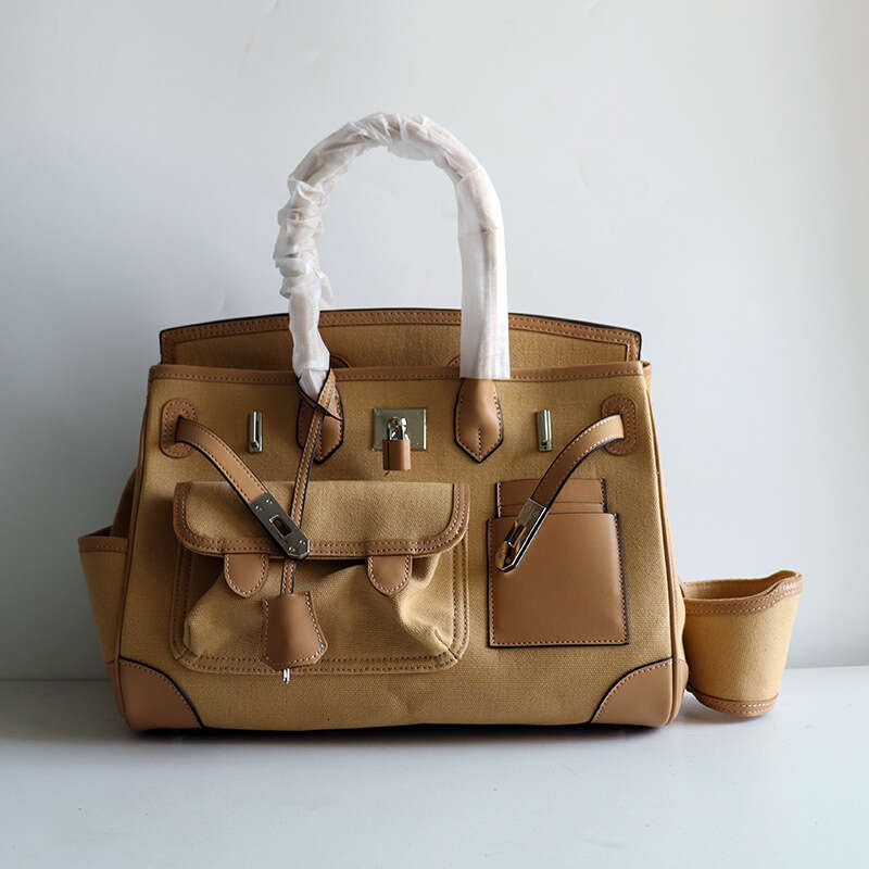 TIINO Canvas Splicing Drawstring Buckle Tote Single Shoulder Diagonal Crossover Head Layer Cowhide Handbag