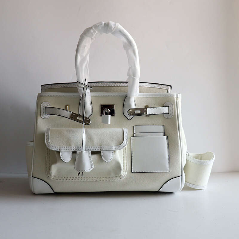 TIINO Canvas Splicing Drawstring Buckle Tote Single Shoulder Diagonal Crossover Head Layer Cowhide Handbag