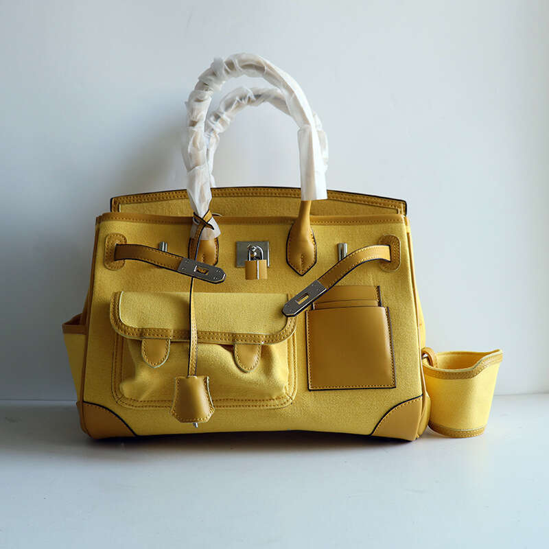 TIINO Canvas Splicing Drawstring Buckle Tote Single Shoulder Diagonal Crossover Head Layer Cowhide Handbag