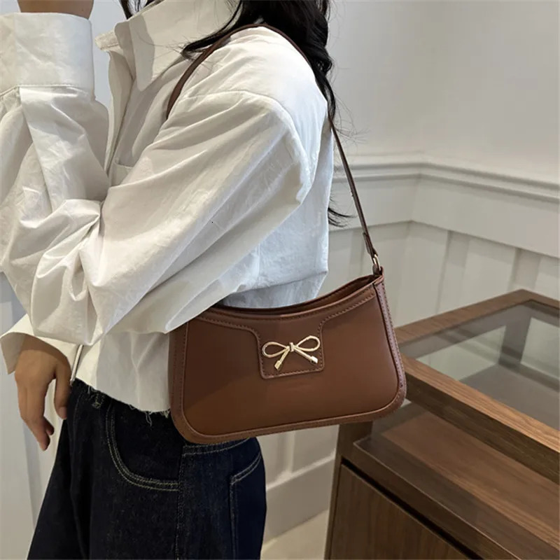 Stylish Shoulder Bag with Metal Bow Decoration Versatile Underarm Bag Classic Brown and Black Baguette Bag for Women Daily Use 250526