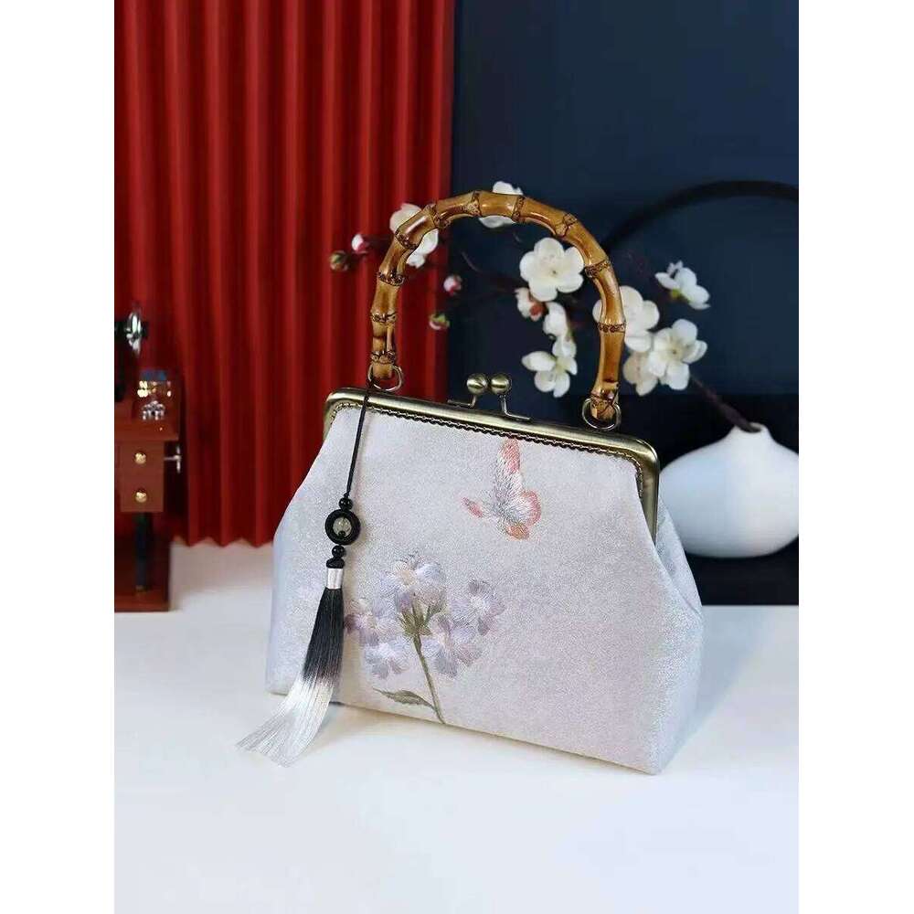 Luxurious and elegant embroidered silk geometric pattern Chinese style bamboo handle gift bag for middle-aged mother with tassel