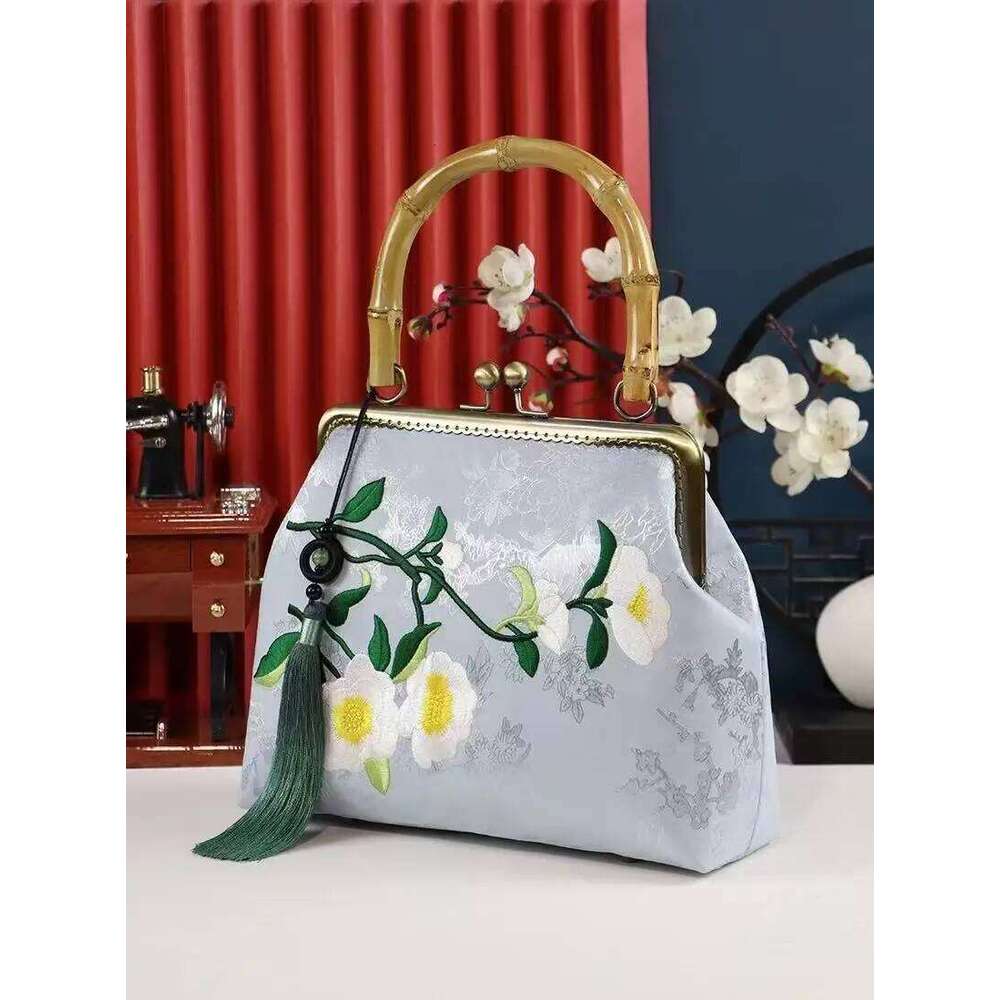 Luxurious and elegant embroidered silk geometric pattern Chinese style bamboo handle gift bag for middle-aged mother with tassel