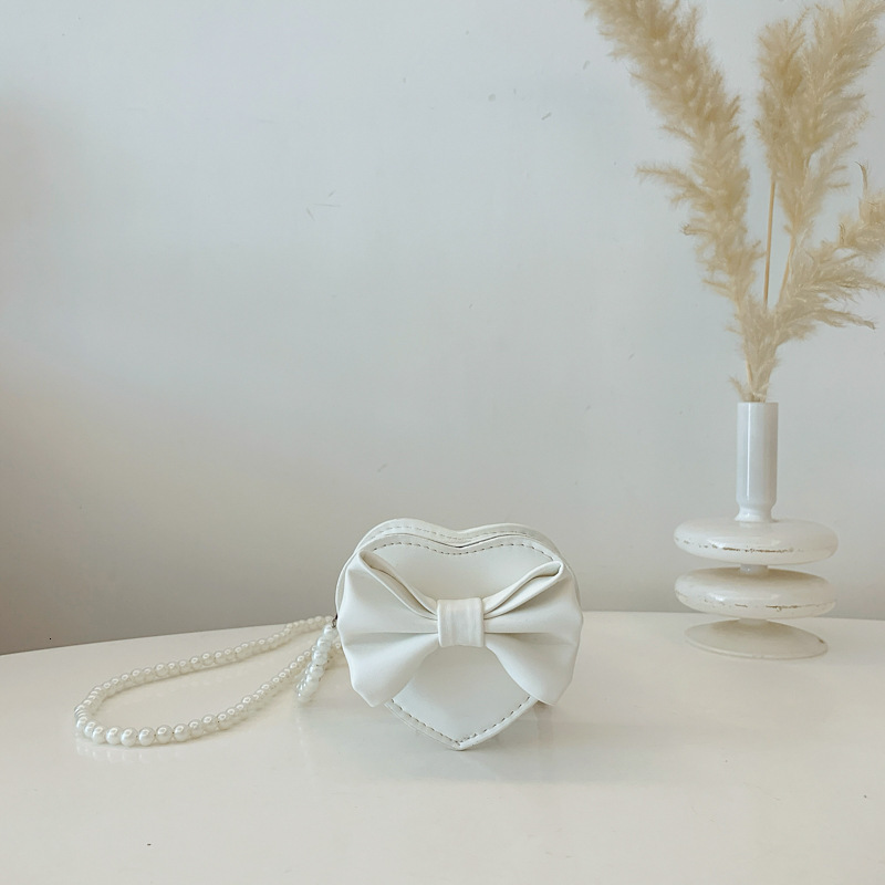 New heart shaped bow children s bag fashionable and sweet girl pearl accessories crossbody fashion bag designer women s fashion shoulder bag