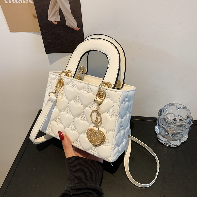 Designer bag Free shipping Lacquer leather heart patterned mini bag with heart-shaped decoration details vintage versatile crossbody bag