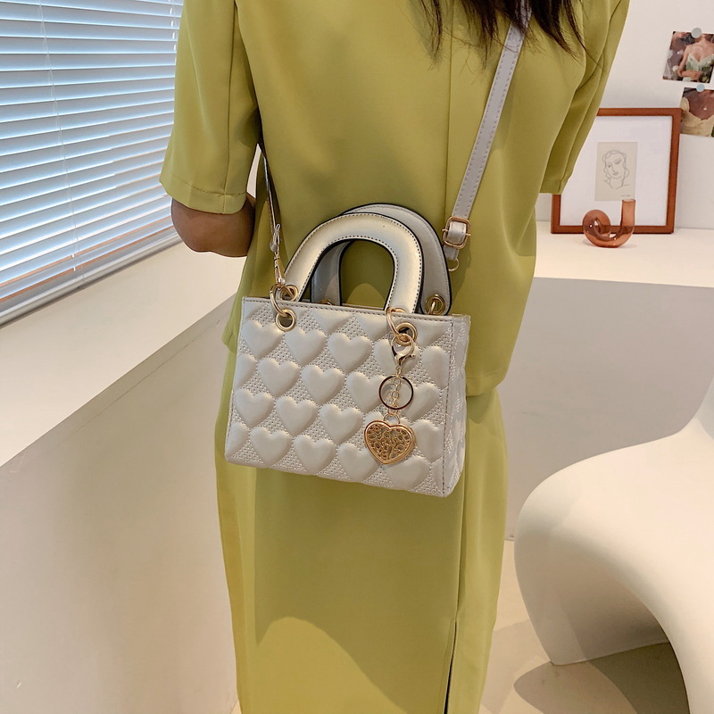 Designer bag Free shipping Lacquer leather heart patterned mini bag with heart-shaped decoration details vintage versatile crossbody bag