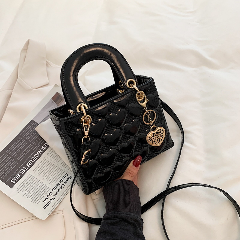 Designer bag Free shipping Lacquer leather heart patterned mini bag with heart-shaped decoration details vintage versatile crossbody bag